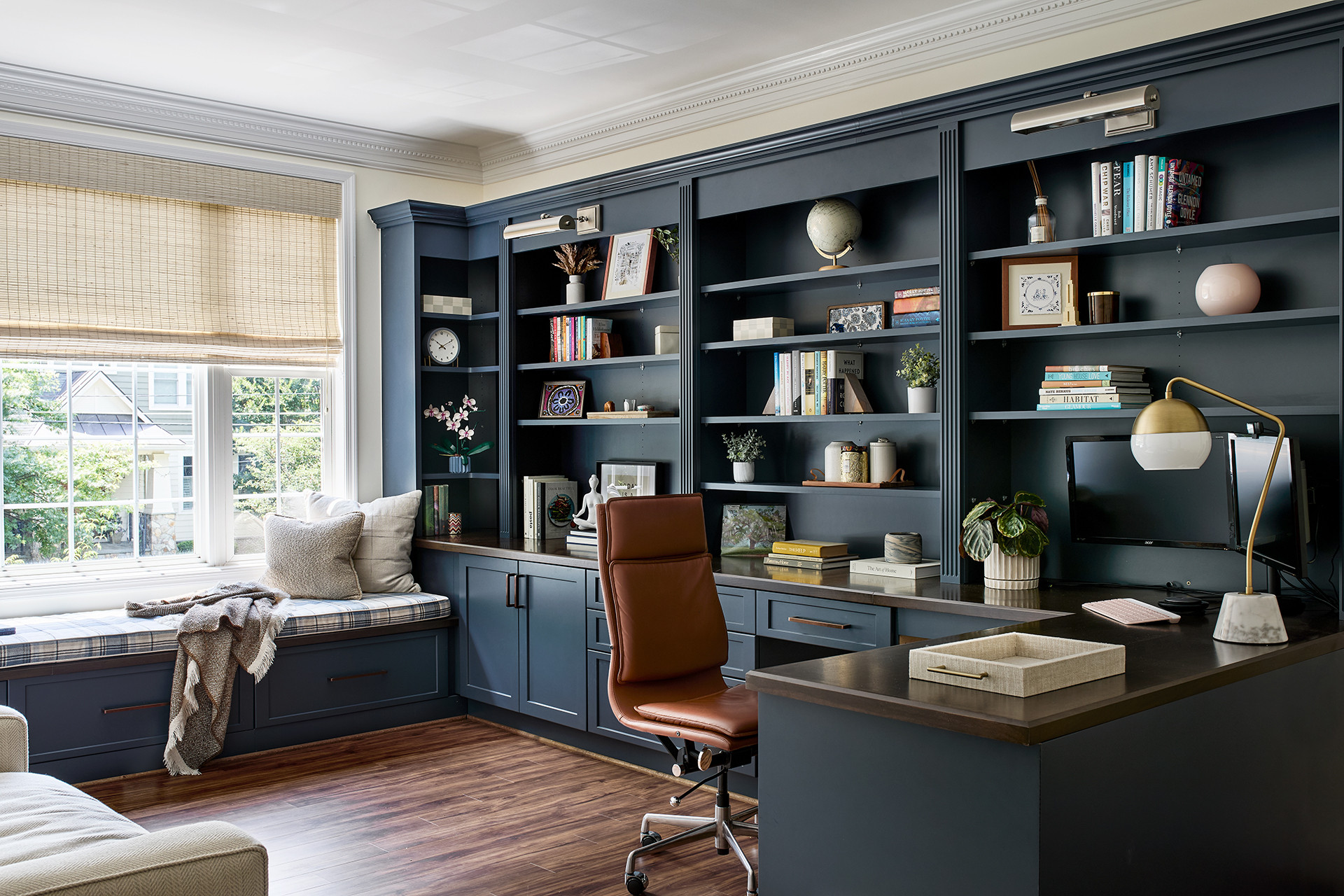 A home office with an adjustable desk and ergonomic chair